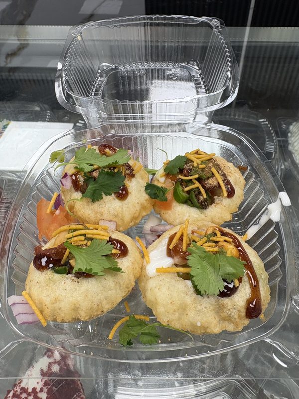 Chaat: crisp puris topped with yogurt, chutney, sev and coriander